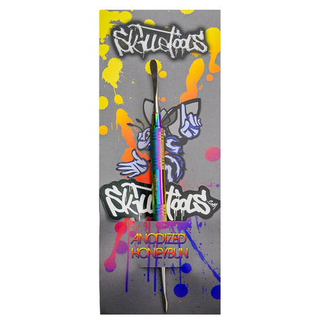 Skilletools Anodized Titanium Dab Tool with Rainbow Finish on Graffiti Background