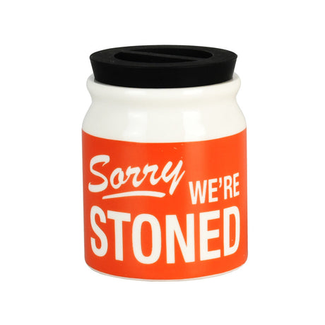 Sorry We're Stoned Ceramic Stash Jar with black silicone lid, front view on white background