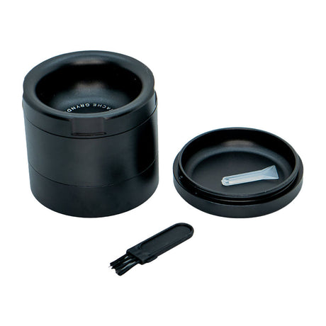 Stache Products Grynder in black, 4-piece 2.5" steel herb grinder with scraper, front view on white background