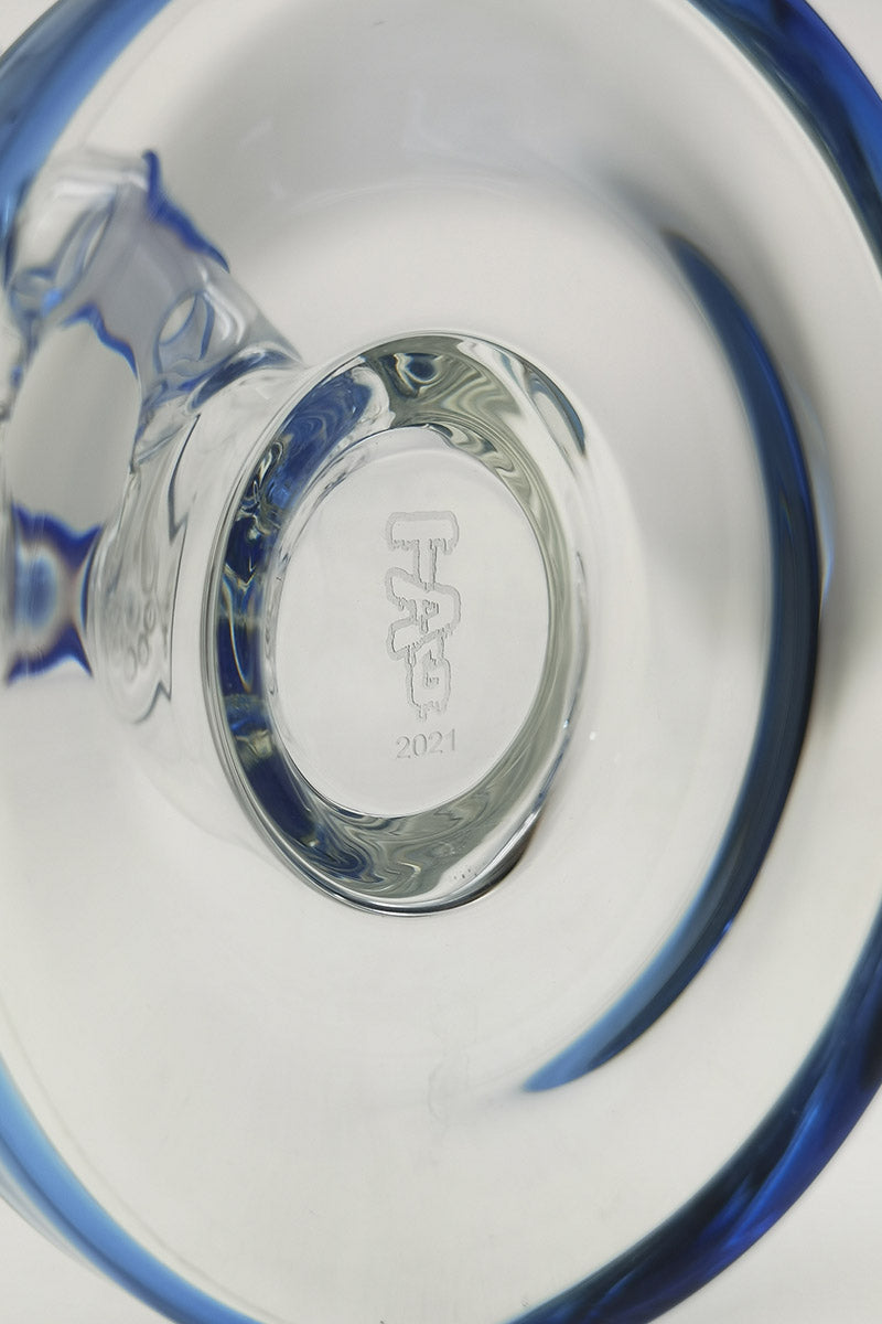 Close-up of TAG straight tube bong base with blue accents and Thick Ass Glass logo
