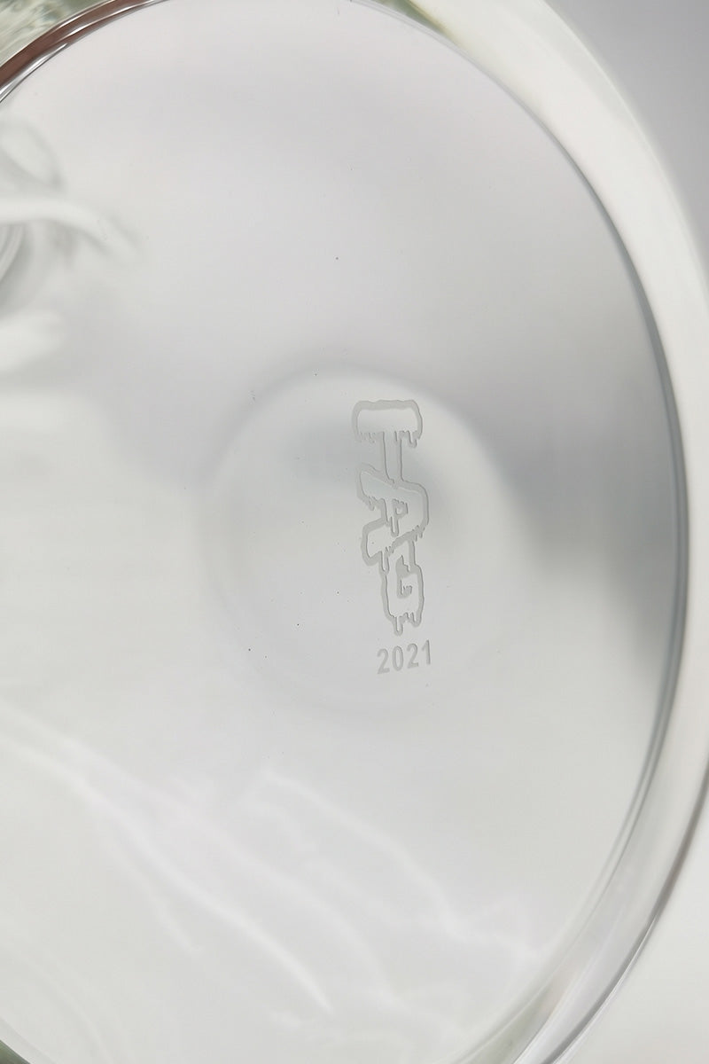 Close-up of TAG logo on 18" Beaker Bong base showcasing quality glass and 2021 engraving