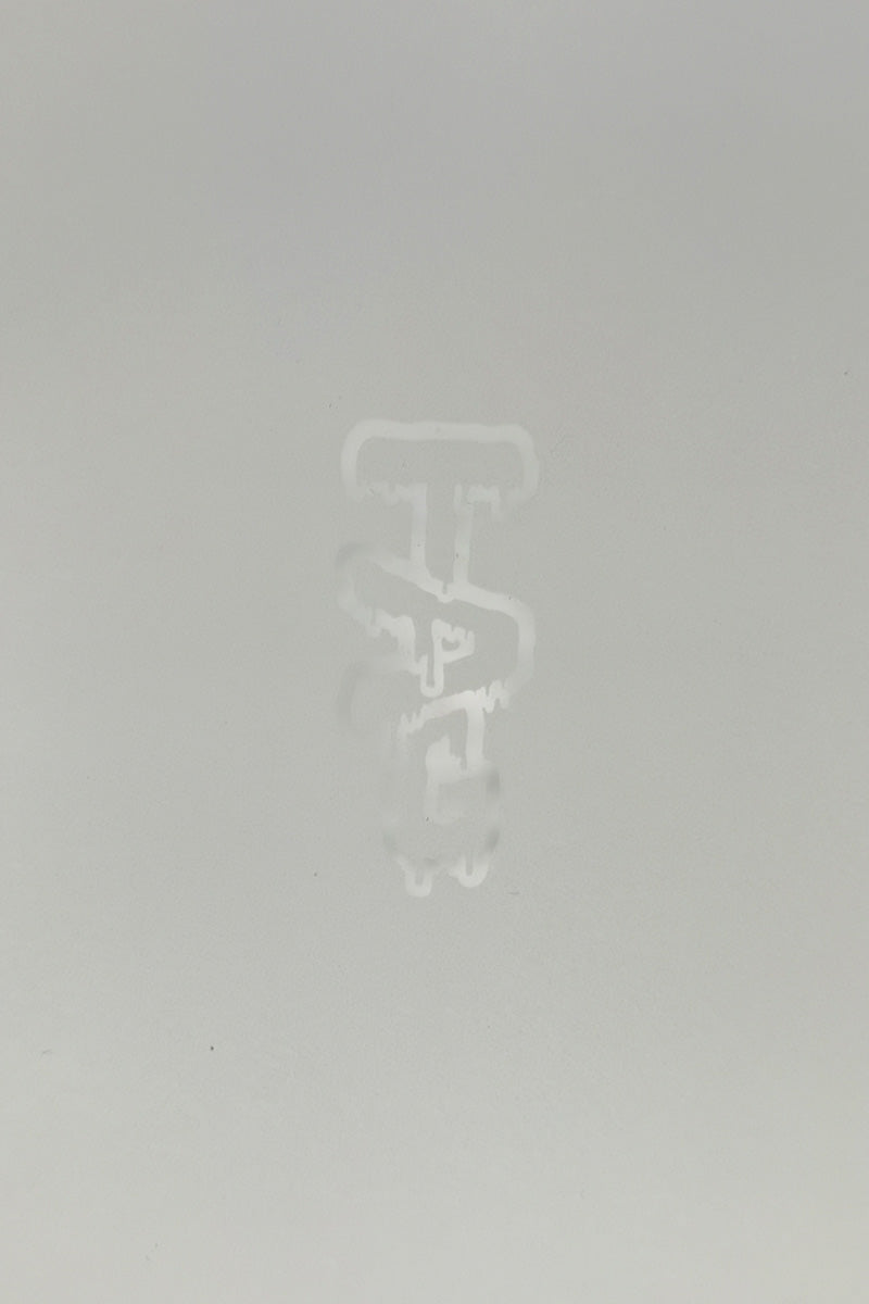 TAG logo close-up on a seamless white background, indicative of Thick Ass Glass bong quality