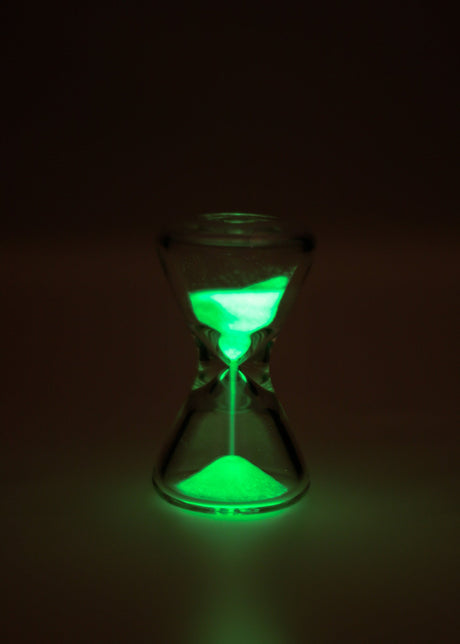 TAG - 3.5" Hour Glass with Glowing Green Sand in Dark Setting