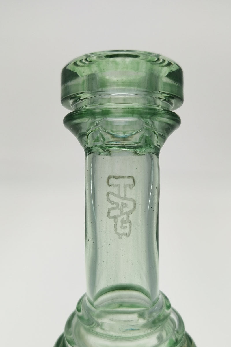 Close-up of TAG 8" Super Slit Puck Klein Incycler's joint with logo, 14MM Female, clear glass