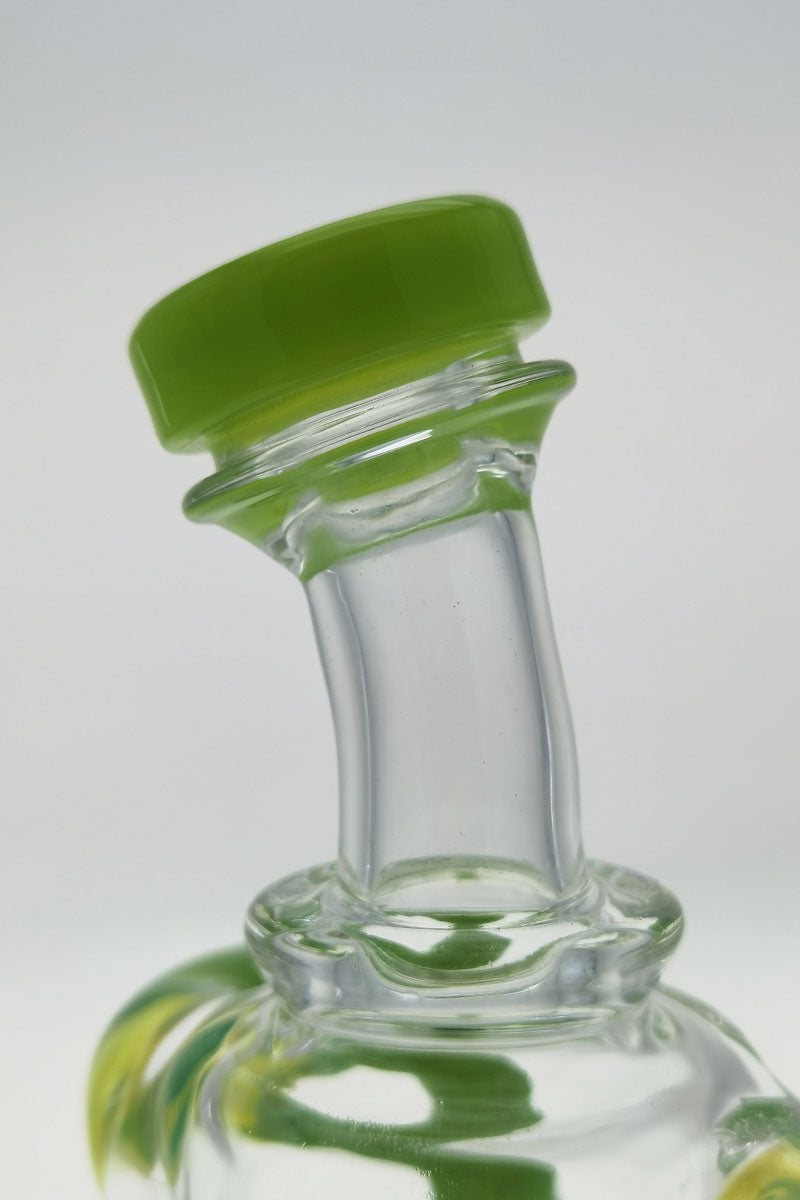 Close-up of TAG 9.5" Super Slit Donut Dual Arm Recycler's 14MM Female joint with green accents
