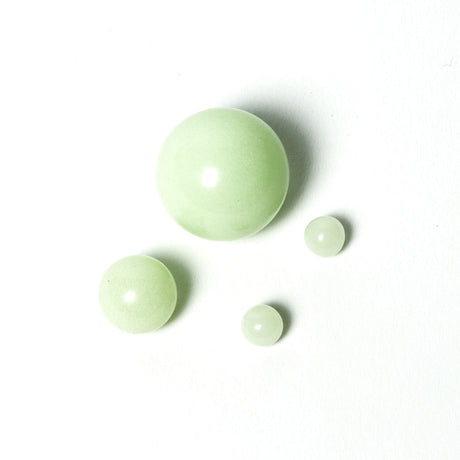aLeaf Terp Pearls 4pc set glowing in soft green, essential for dab rigs, on white background