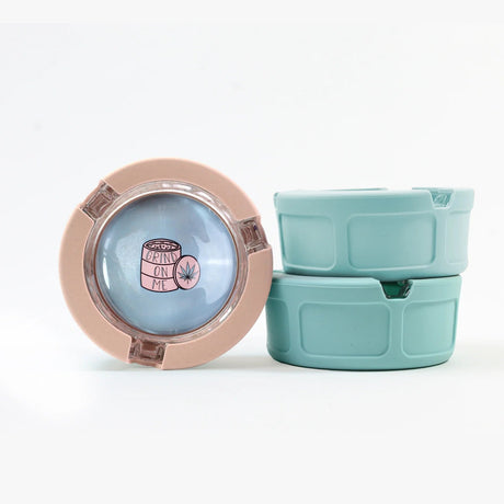 Ugly House Giddy Glass Ashtrays in pink and blue, compact design, front view on white background