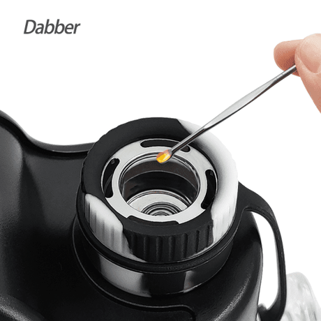 Close-up of Waxmaid electric dab rig in black with dabber tool and concentrate