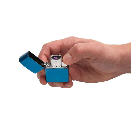 Hand holding Zippo Rechargeable Lighter Insert - Arc, showing the purple electric arc, portable design