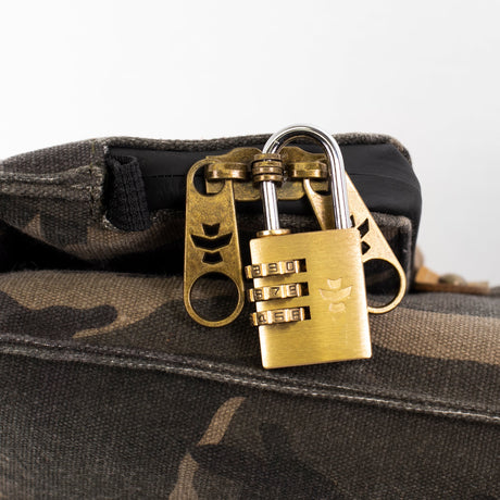 Revelry Supply Drifter Rolltop Backpack, camo design, with secure brass lock, close-up view