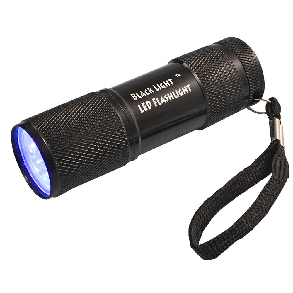 Compact black LED flashlight with black light on, side view with wrist strap on white background
