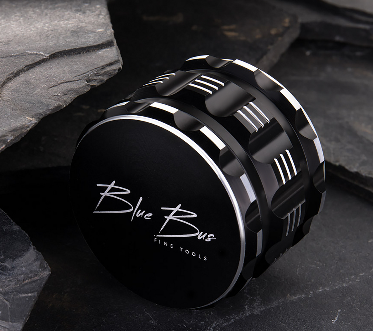 Blue Bus M1 Aluminum 4-Part Herb Grinder in Black, Compact Design, on Stone Background