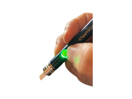 Helio Supply Budder Knife in use, electronic dab tool with ceramic tip, green light indicator