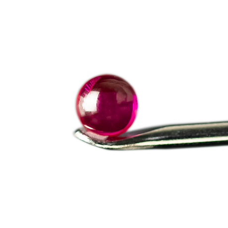 Close-up of MJ Arsenal Ruby Terp Pearl on metal tool against a white background, enhancing dab rig efficiency