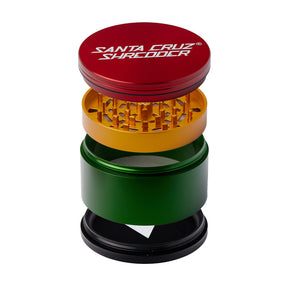 Santa Cruz Shredder Jumbo 4 Piece Grinder in Rasta colors, front view with visible teeth