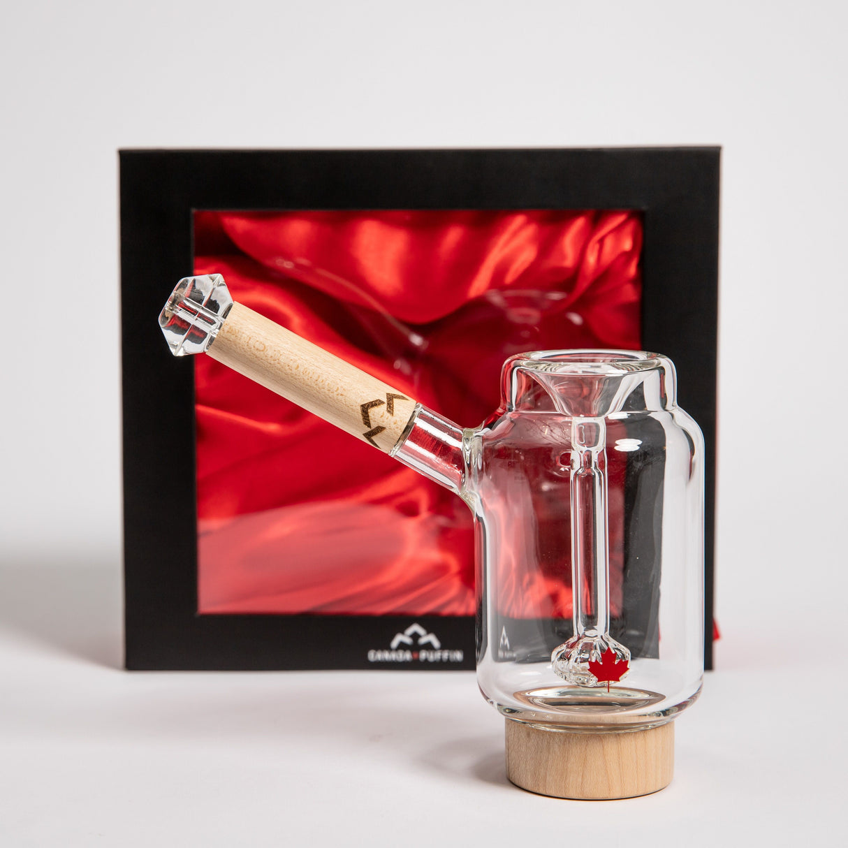 Canada Puffin Arctic Bubbler front view with wooden base and red satin background