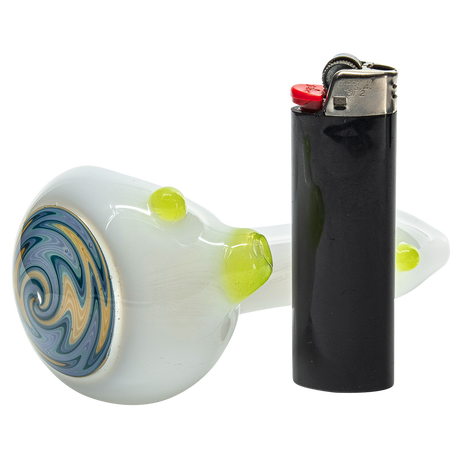 LA Pipes 6.25" Ivory Wig-Wag Spoon Pipe with intricate swirl design, side view next to lighter