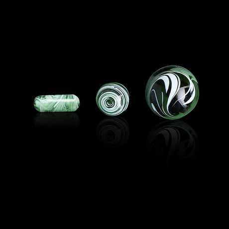 Honeybee Herb Dab Marble Sets in assorted colors, displayed on reflective surface