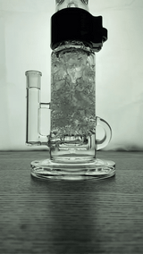 Prism KLEIN INCYCLER SINGLE STACK with water action, clear glass, front view on wooden surface