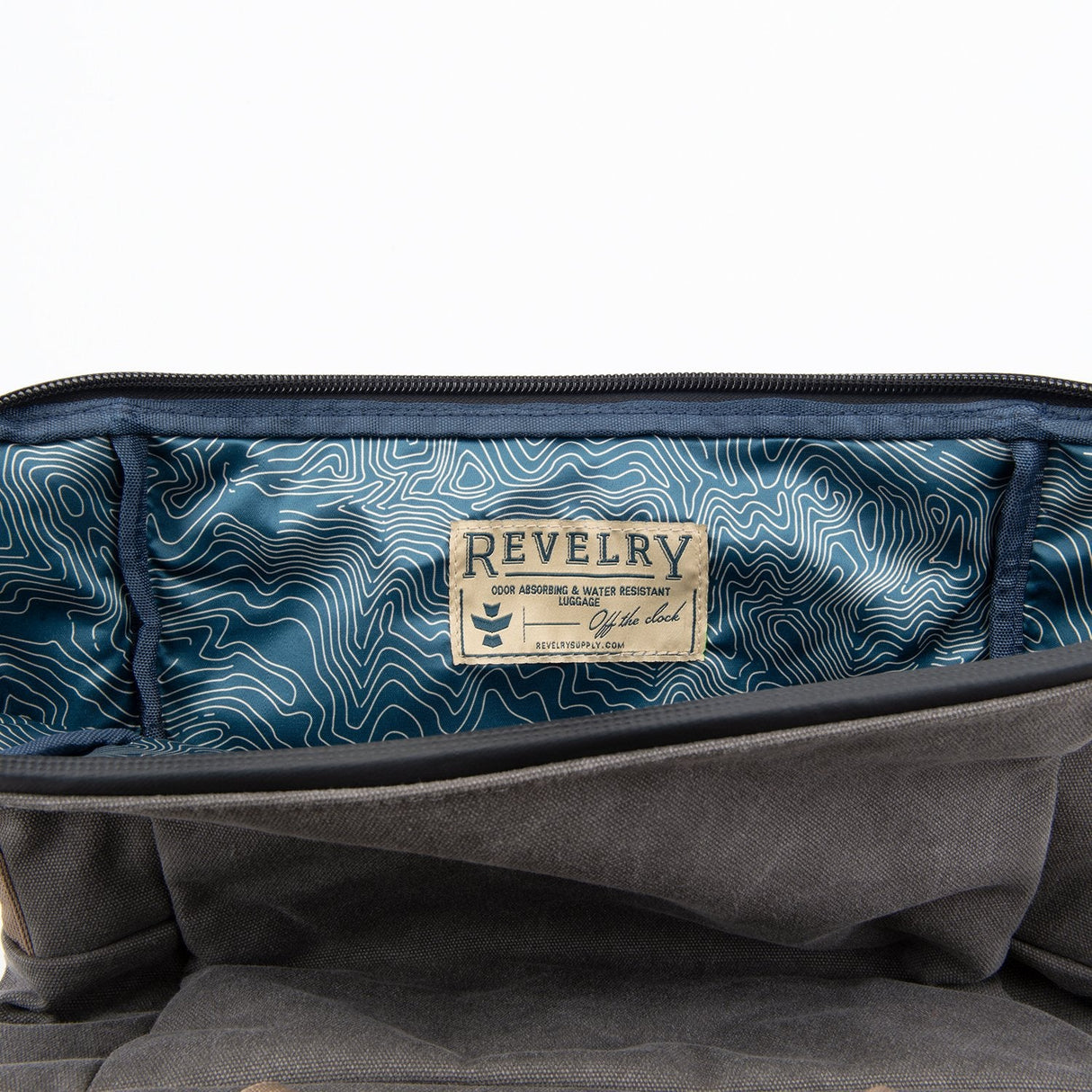Close-up view of The Drifter Smell Proof Rolltop Backpack by Revelry Supply with open compartment
