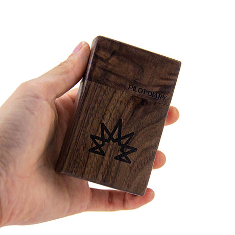 Hand holding PILOT DIARY Wood Dugout with Glass One Hitter Pipe, Front View