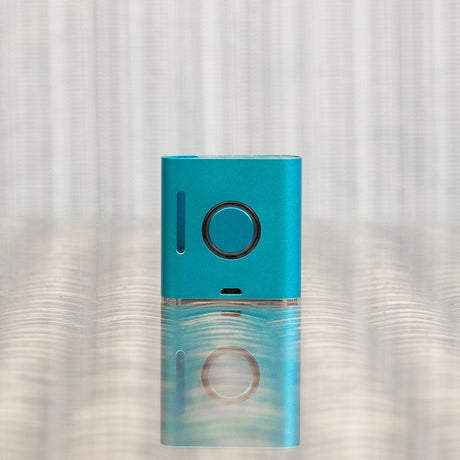 Helio Supply SolPod Express Kit in Teal, Compact Vaporizer Front View on Reflective Surface
