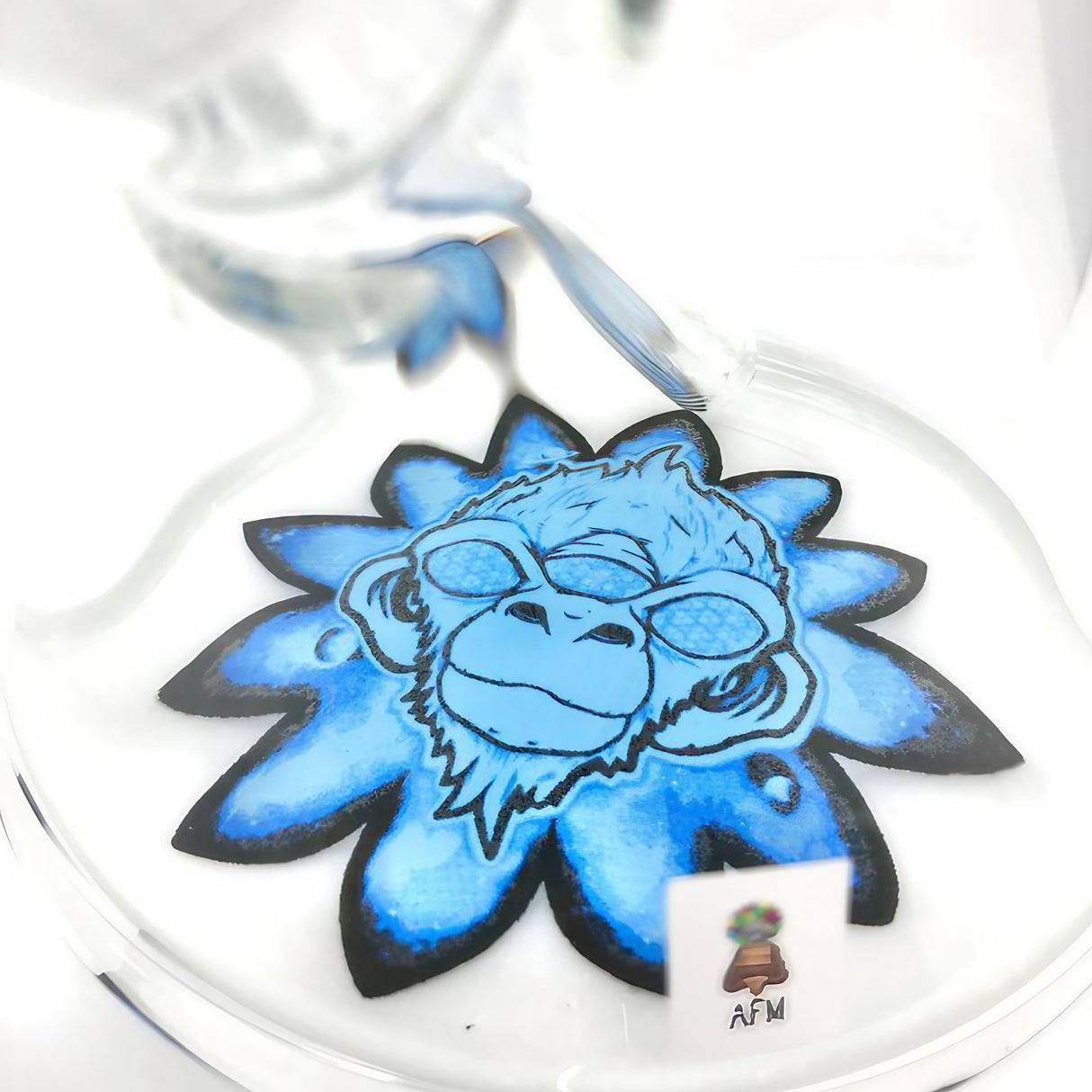Close-up of AFM Glass Flower Monkey 9mm Beaker's base with intricate blue monkey design