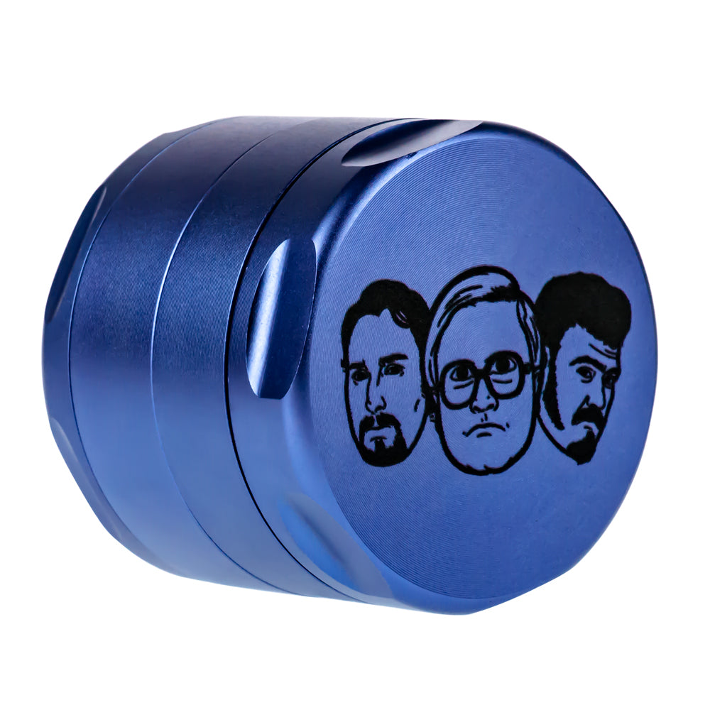 Blue aluminum 4-part grinder with diamond-shaped teeth and iconic faces design, compact for travel.