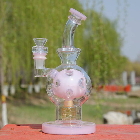 Calibear EXOSPHERE Dab Rig in Milky Pink with Seed of Life Perc, 8 Inch, Front View on Outdoor Table