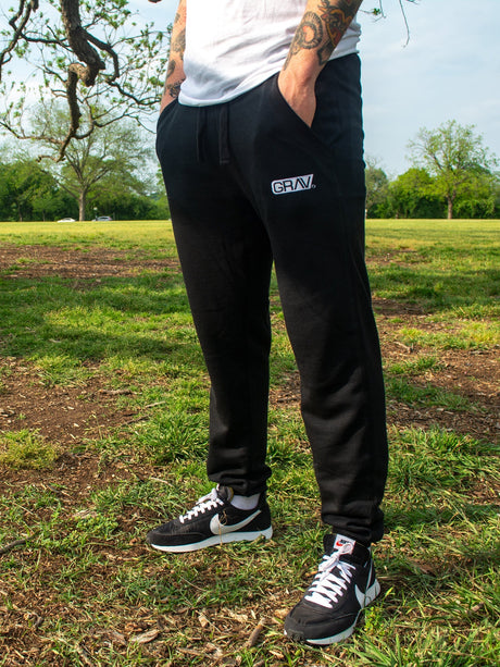GRAV Slim-fit Black Joggers with Logo on Left Thigh - Outdoor Side View