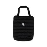 Higher Standards black quilted tote bag with white logo, front view on a seamless background