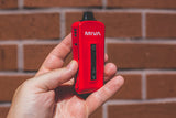 KandyPens MIVA 2 Vaporizer in hand, portable design with power button, front view on brick background