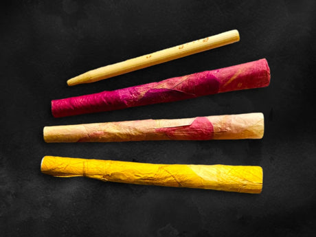LaRosé Rose Petal Blunt Rolls in yellow, pink, and natural colors, top view on black background