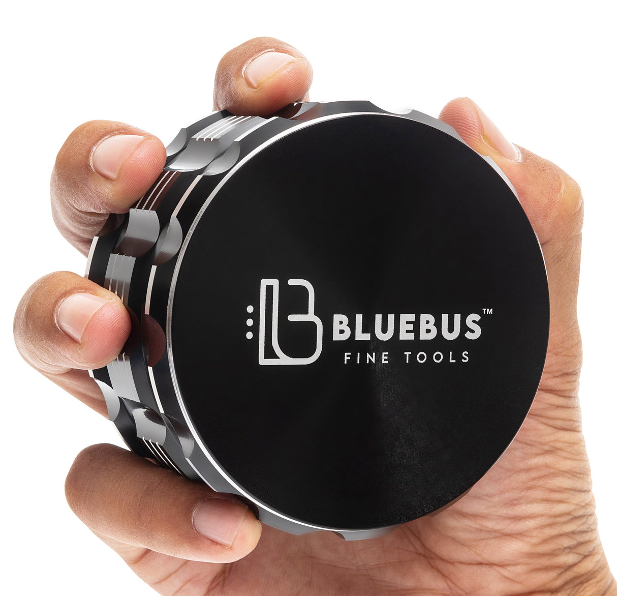 Hand holding Black GA Aluminum Grinder by Blue Bus Fine Tools, 3.5" size, front view on white background