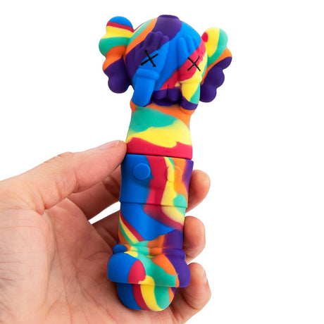 Colorful Kaws Silicone Pipe by PILOTDIARY held in hand, front view, easy to clean, portable