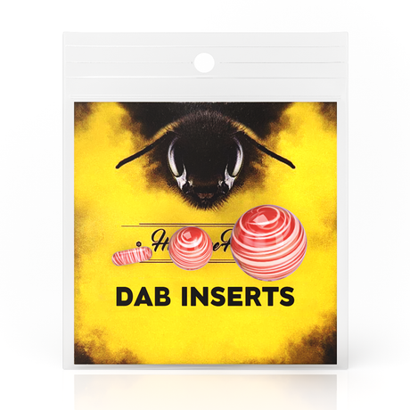 Honeybee Herb Dab Marble Set with red swirl design, front view on yellow branded packaging
