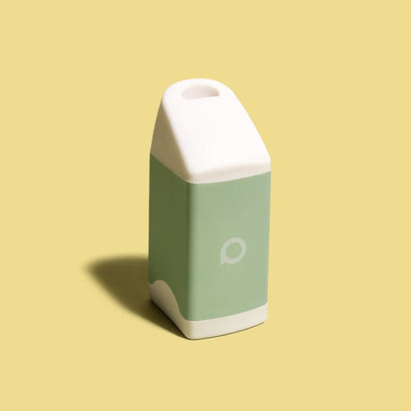 Light green PHREND by Philter Labs, front view on a yellow background, portable smoke filter
