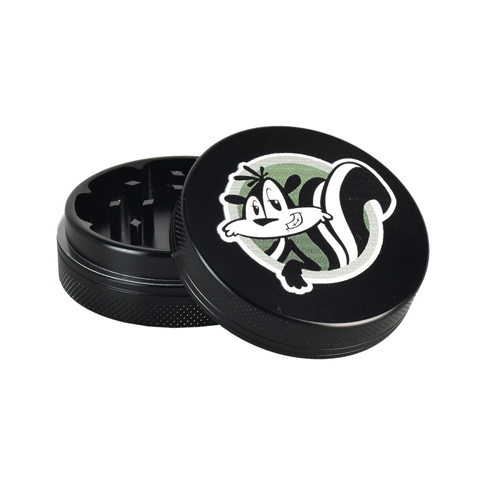 Skunk Brand Shredder Grinder, black 2-part compact aluminum design with fun skunk graphic, front view