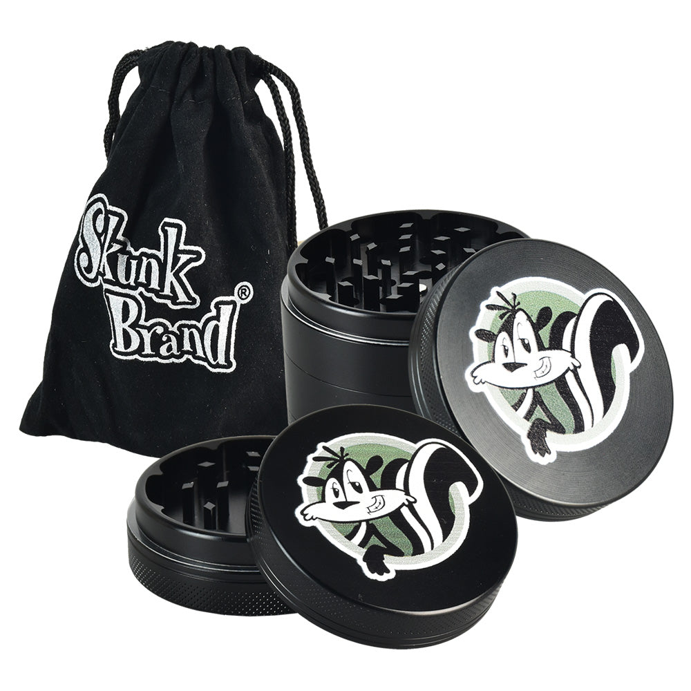 Skunk Brand Shredder Grinder in black with fun skunk design, portable 4-part aluminum build, and carry pouch