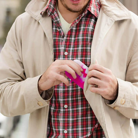Man holding PILOT DIARY Silicone Dugout One Hitter Set in Pink, compact for easy travel