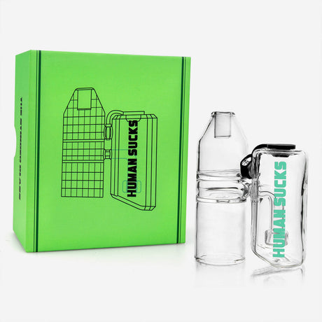 HUMANSUCKS STINGER Glass Bubbler with clear body, front view, beside vibrant green box