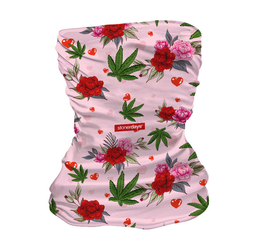 StonerDays pink neck gaiter with cannabis leaves and red flowers design, front view