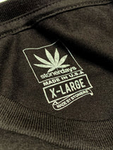 Close-up of StonerDays Dank Trees T-Shirt label showing size X-Large and Made in USA