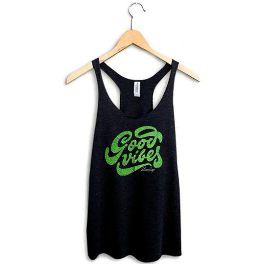 StonerDays Groovy Vibes Racerback tank top in black with green print, hanging on wooden hanger