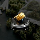 StonerDays Exclusive Dab Bucket Pin Set on a black surface surrounded by cannabis buds