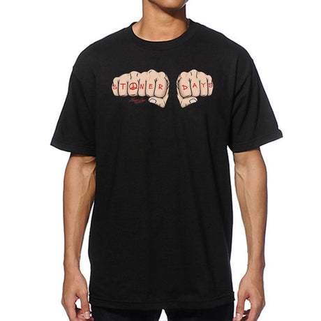 Man wearing StonerDays Knuckle Up black t-shirt with bold lettering across knuckles, front view