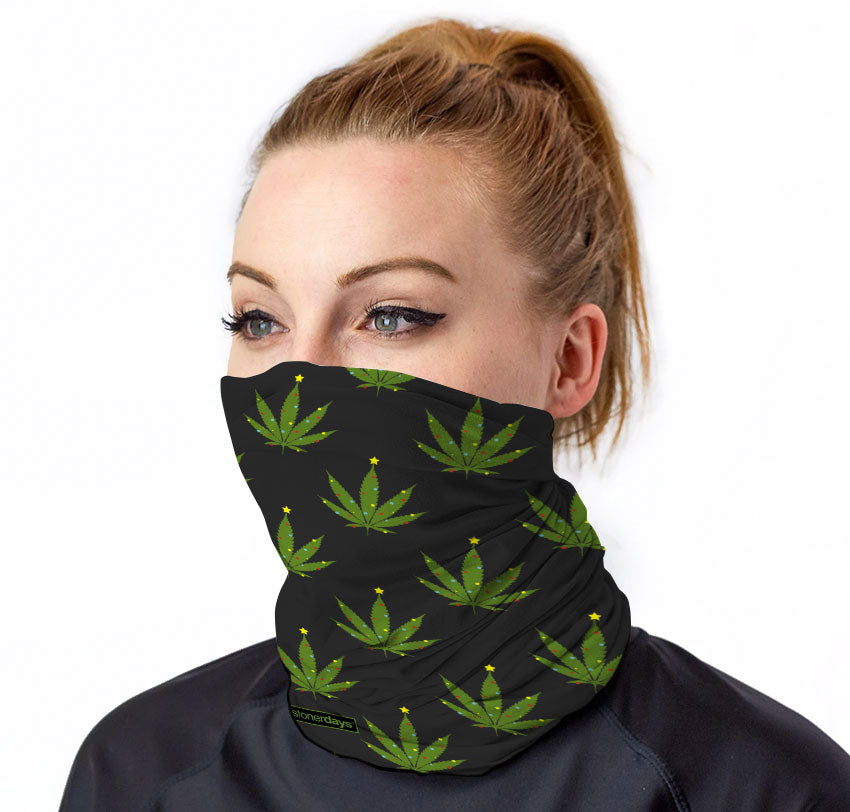 StonerDays Lit Like A Christmas Tree Neck Gaiter in green with cannabis leaf pattern, front view on model