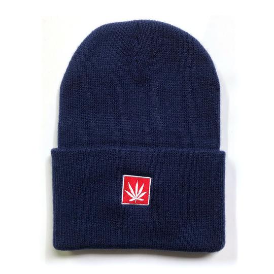 StonerDays navy beanie with red cannabis leaf emblem, front view on white background