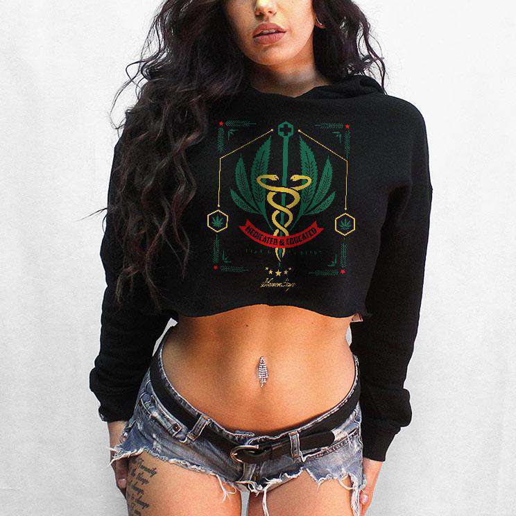 StonerDays Medicated And Educated black crop top hoodie with cannabis design, front view on model