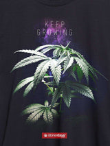 StonerDays Men's Keep Growing Tee in black cotton, close-up front view with cannabis leaf design